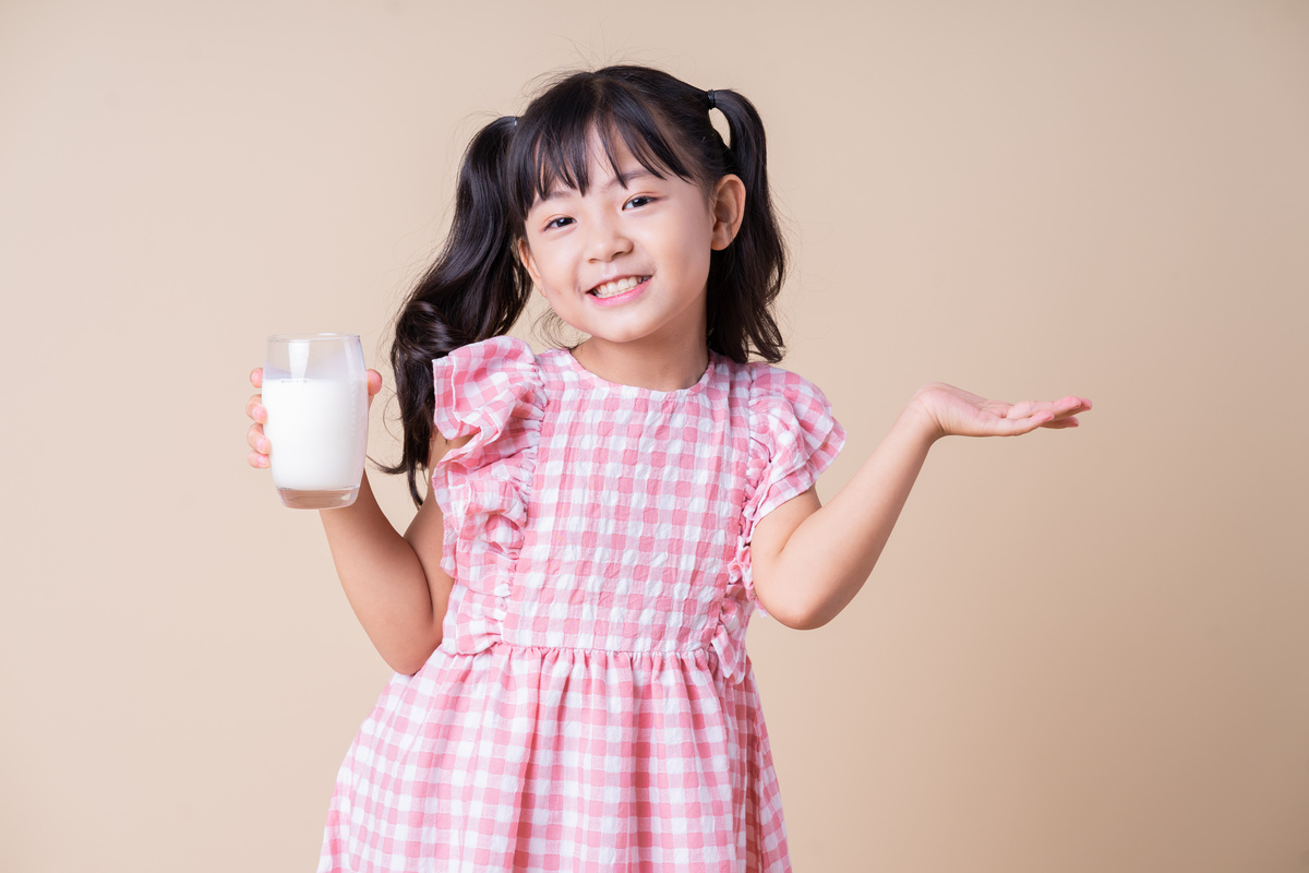 Image of Asian Child Drinking Milk on Background